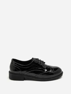 New La Modeuse Derbies vernies à détails ajourés Noir