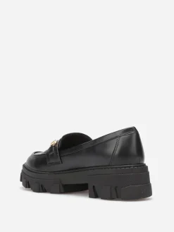 New La Modeuse Mocassins crantés à détail métallique Noir