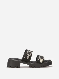 Sale La Modeuse Mules à boucles et clous argentés Noir