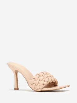 La Modeuse Mules à bride matelassée et tressée Beige