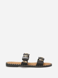 New La Modeuse Mules à brides festonnées et détails dorés Noir