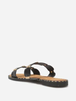 New La Modeuse Mules à brides festonnées et détails dorés Noir