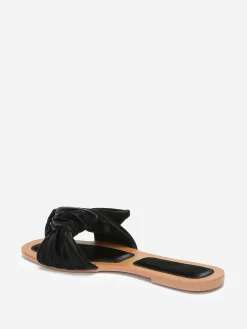 La Modeuse Mules à large bride matelassée et nouée Noir