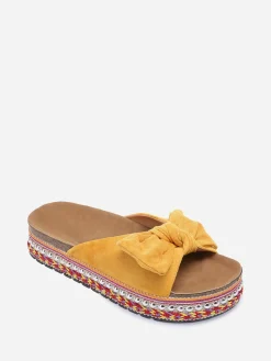 New La Modeuse Mules  à noeud et semelle à motifs Jaune