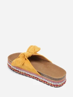 New La Modeuse Mules  à noeud et semelle à motifs Jaune