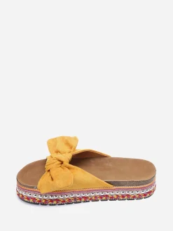 New La Modeuse Mules  à noeud et semelle à motifs Jaune
