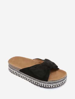 New La Modeuse Mules  à noeud et semelle à motifs Noir