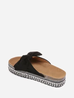 New La Modeuse Mules  à noeud et semelle à motifs Noir
