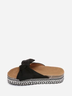 New La Modeuse Mules  à noeud et semelle à motifs Noir