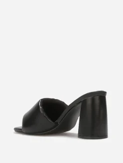 La Modeuse Mules à talon et bride rembourrée Noir