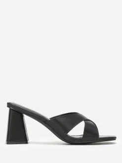 Discount La Modeuse Mules à talon trapèze et brides croisées Noir