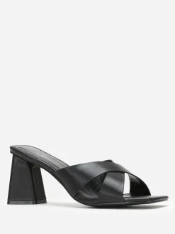 Discount La Modeuse Mules à talon trapèze et brides croisées Noir