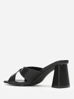 Discount La Modeuse Mules à talon trapèze et brides croisées Noir