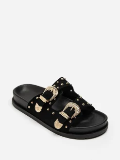 Outlet La Modeuse Mules en suédine à boucles et clous dorés Noir