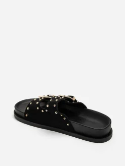 Outlet La Modeuse Mules en suédine à boucles et clous dorés Noir