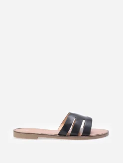 La Modeuse Mules plates à bride ajourée et clous Noir
