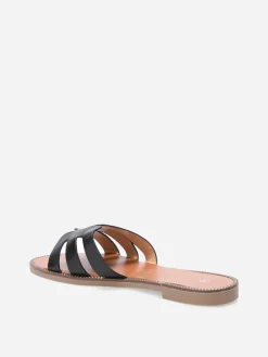 La Modeuse Mules plates à bride ajourée et clous Noir