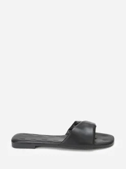 La Modeuse Mules plates à bride torsadée en simili Noir