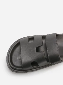 Discount La Modeuse Mules plates à brides ajourées Noir