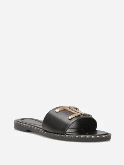New La Modeuse Mules plates à détails dorés Noir