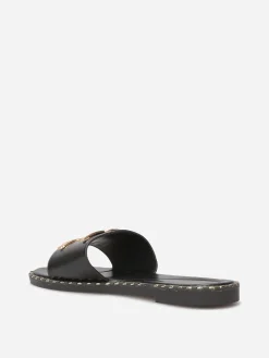 New La Modeuse Mules plates à détails dorés Noir