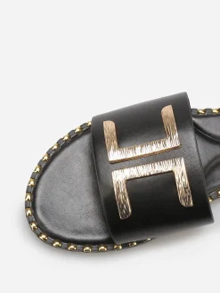New La Modeuse Mules plates à détails dorés Noir