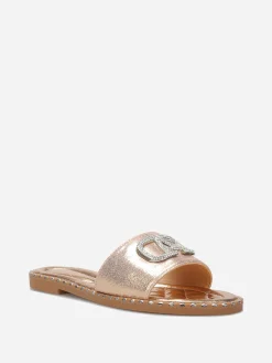 Outlet La Modeuse Mules plates à strass et clous Dorérose